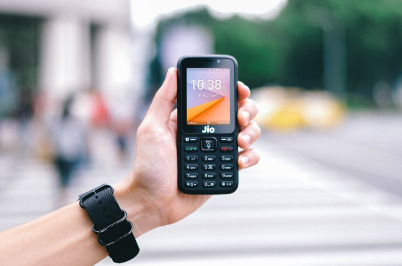 A hand holding a JioPhone