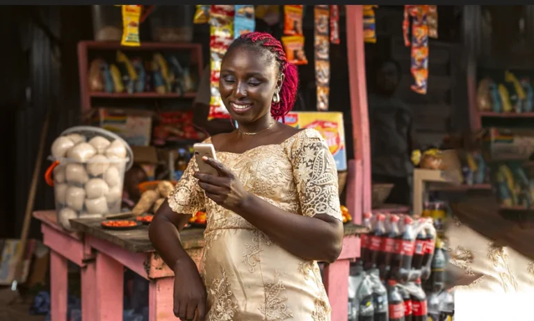 A merchant using a mobile phone at a local shop