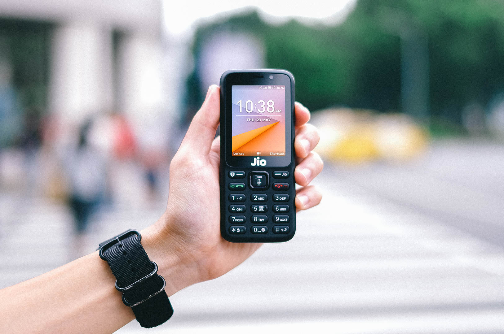 A hand holding a JioPhone